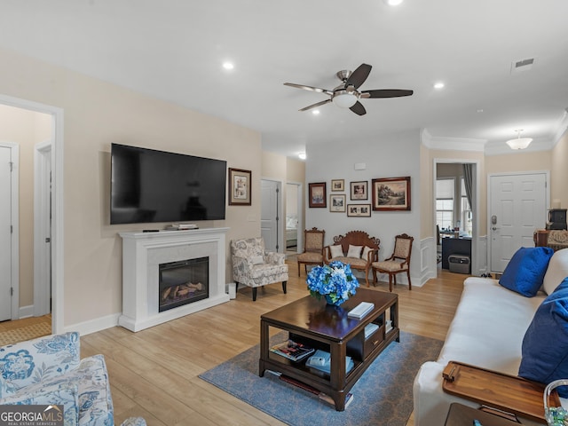 living room featuring ceiling fan and light hardwood / wood-style flooring