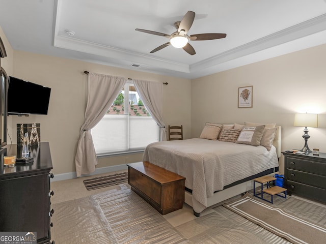 carpeted bedroom with ceiling fan, a raised ceiling, and crown molding
