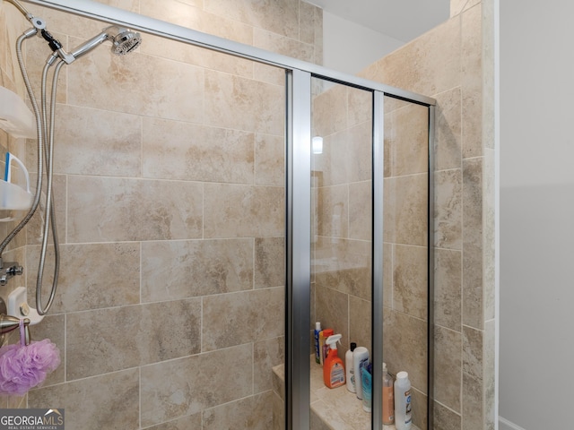 bathroom featuring a shower with shower door