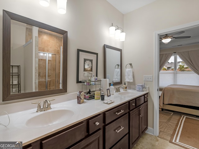 bathroom featuring tile patterned flooring, ceiling fan, an enclosed shower, and vanity