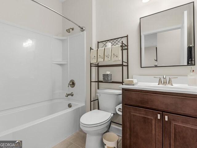 full bathroom with washtub / shower combination, vanity, toilet, and tile patterned flooring