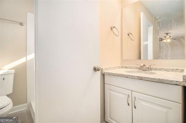 bathroom featuring a shower, ceiling fan, vanity, and toilet