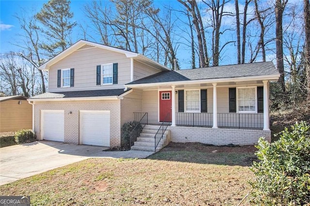 tri-level home featuring a garage and a front lawn