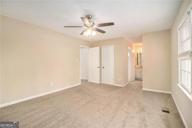 carpeted empty room featuring ceiling fan