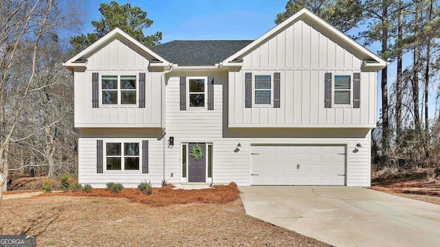 view of front of house featuring board and batten siding, an attached garage, driveway, and a shingled roof