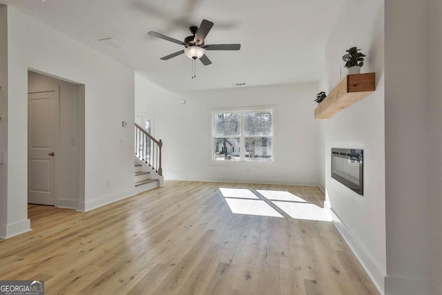 unfurnished living room featuring light hardwood / wood-style flooring and ceiling fan