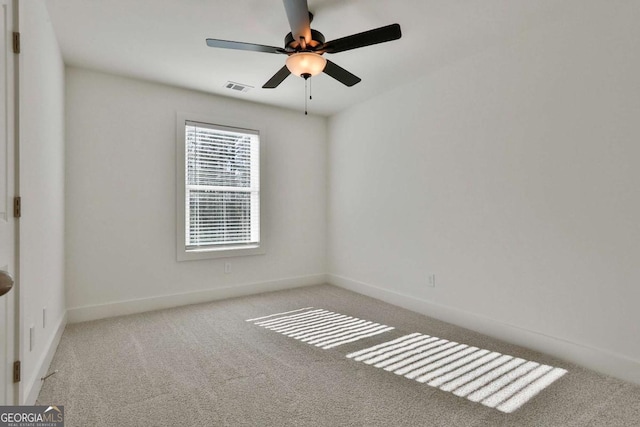 spare room with light carpet and ceiling fan