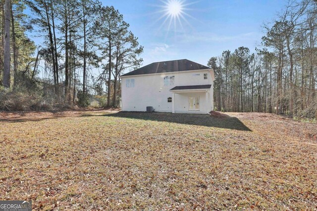 view of side of home with a lawn