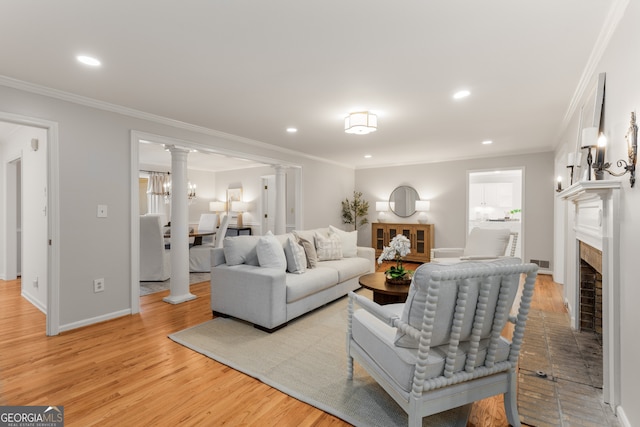 living room with light hardwood / wood-style floors and crown molding