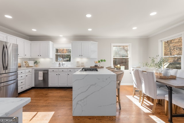 kitchen with white cabinetry, sink, dark wood-type flooring, stainless steel appliances, and decorative backsplash