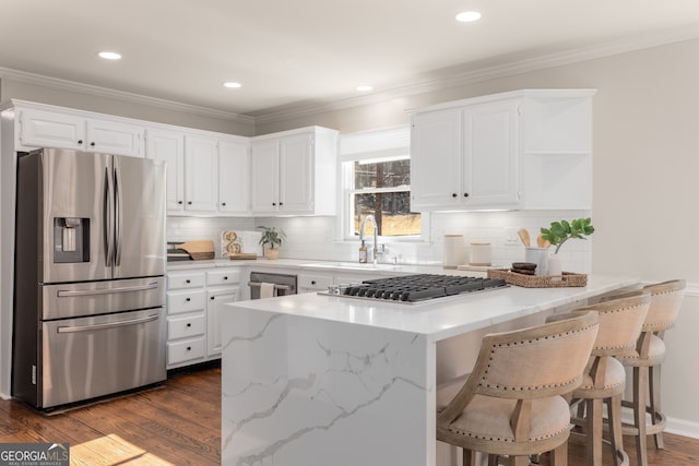 kitchen with dark hardwood / wood-style flooring, white cabinetry, sink, and stainless steel appliances