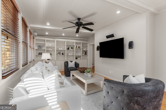 living room with ceiling fan, beam ceiling, light wood-type flooring, and built in features