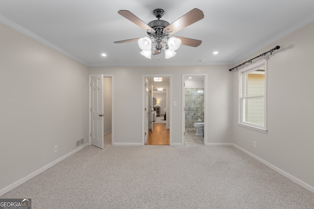 unfurnished bedroom featuring ceiling fan, crown molding, light carpet, and connected bathroom