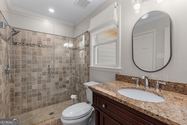 bathroom with toilet, vanity, an enclosed shower, and ornamental molding