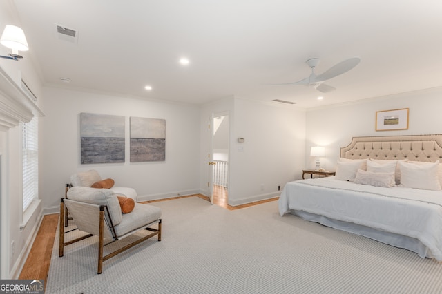 bedroom with light wood-type flooring, ceiling fan, and ornamental molding