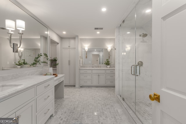 bathroom featuring vanity and a shower with shower door