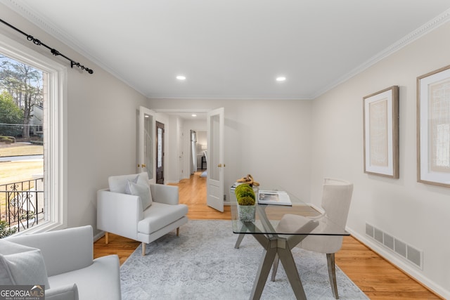 office space with light hardwood / wood-style flooring and ornamental molding