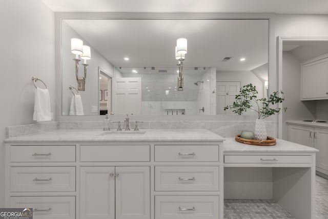 bathroom with vanity and tiled shower