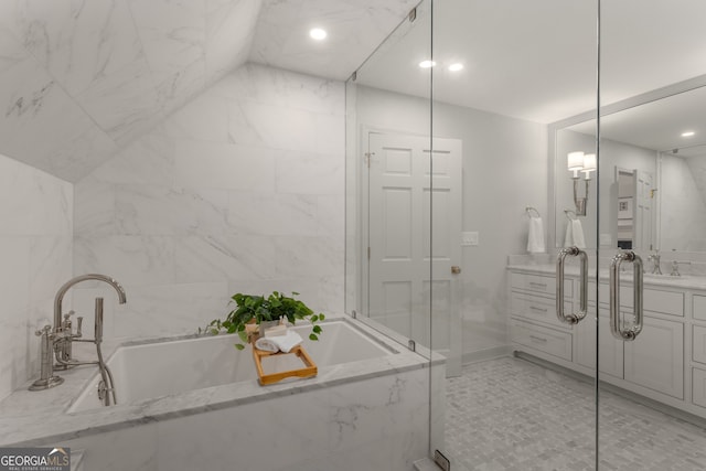 bathroom with vanity, separate shower and tub, and tile walls