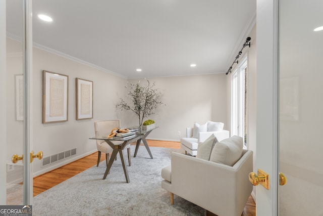 office area featuring wood-type flooring and ornamental molding