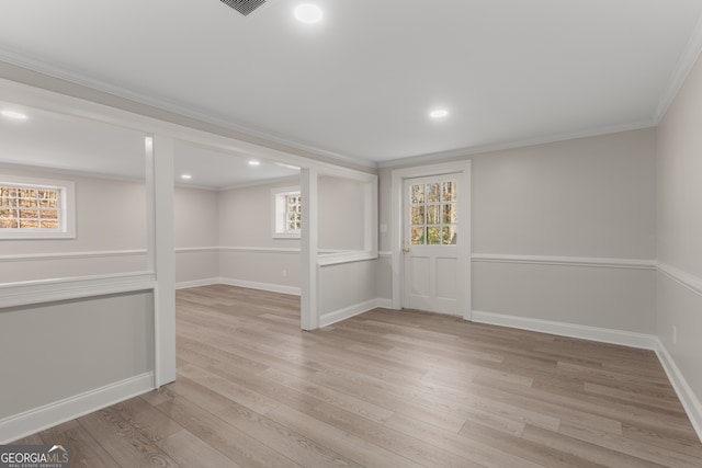 unfurnished room featuring light hardwood / wood-style flooring and ornamental molding