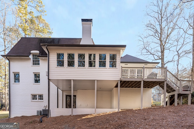 back of property featuring a deck and cooling unit