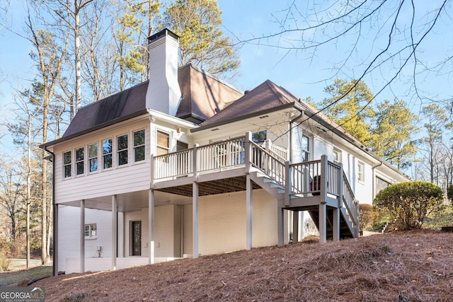 rear view of property featuring a deck