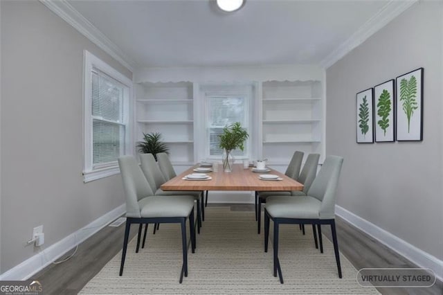 dining area with built in shelves, wood-type flooring, and ornamental molding