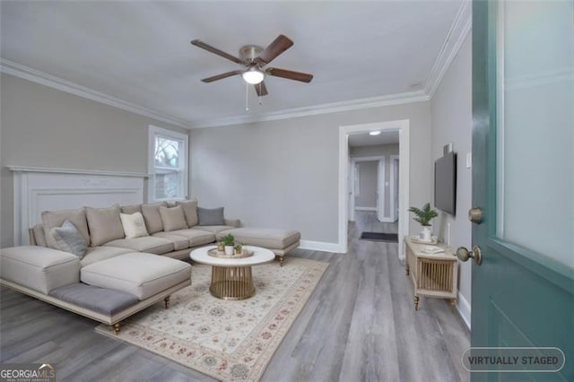 living room with crown molding, ceiling fan, and light hardwood / wood-style floors