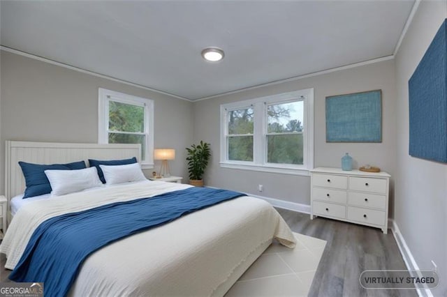 bedroom with multiple windows, crown molding, and dark hardwood / wood-style floors