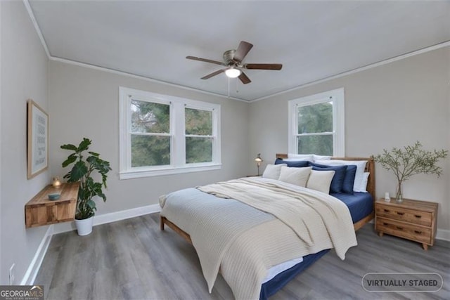 bedroom featuring ceiling fan, crown molding, and multiple windows