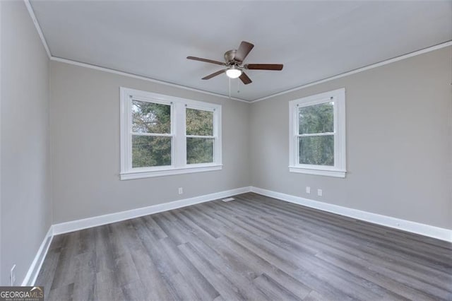 spare room featuring hardwood / wood-style flooring, ceiling fan, and ornamental molding