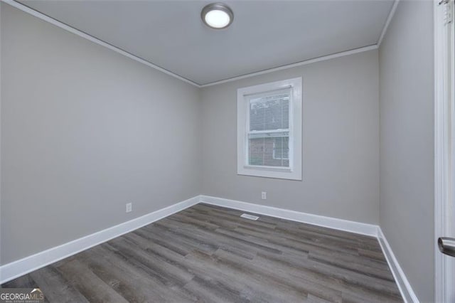 spare room with hardwood / wood-style flooring and ornamental molding