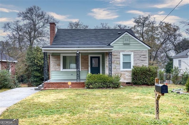 bungalow-style home featuring a front lawn and a porch