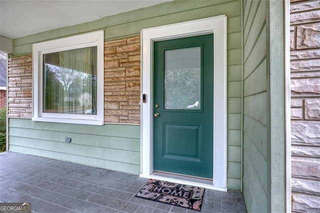 view of exterior entry with covered porch