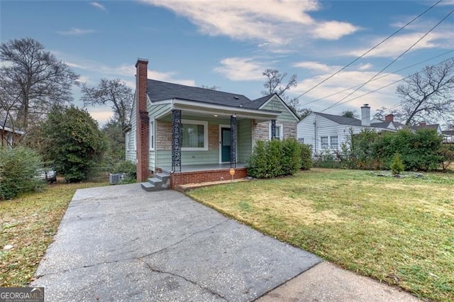 bungalow with a front yard and covered porch