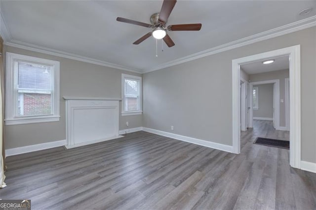 interior space with hardwood / wood-style flooring, ceiling fan, and ornamental molding