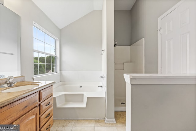 bathroom with tile patterned flooring, vanity, lofted ceiling, and independent shower and bath