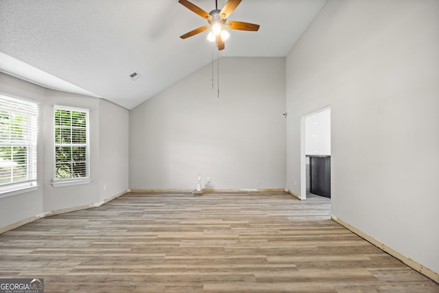 unfurnished living room with light hardwood / wood-style floors, vaulted ceiling, and ceiling fan