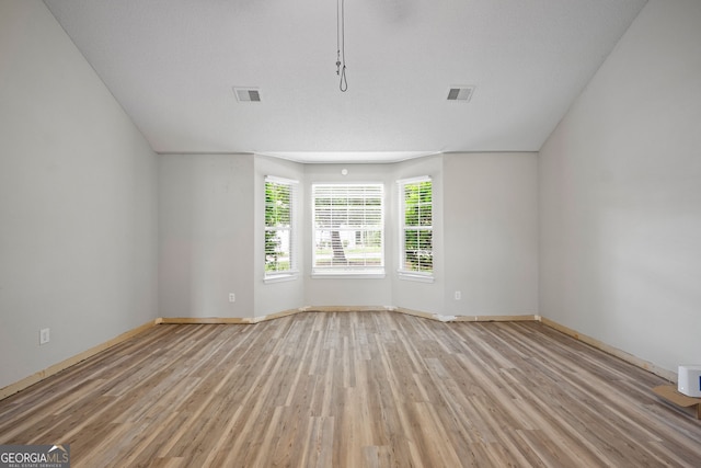 unfurnished room with light hardwood / wood-style floors