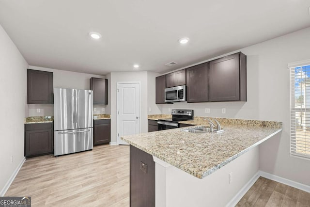 kitchen with dark brown cabinets, sink, and appliances with stainless steel finishes