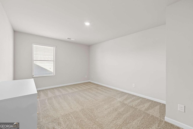 empty room featuring light colored carpet