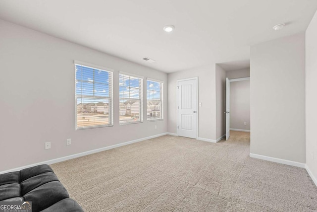 unfurnished room featuring light colored carpet