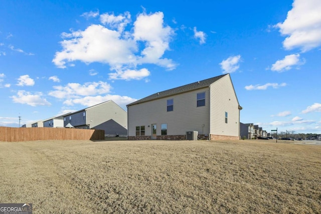 rear view of property featuring central AC