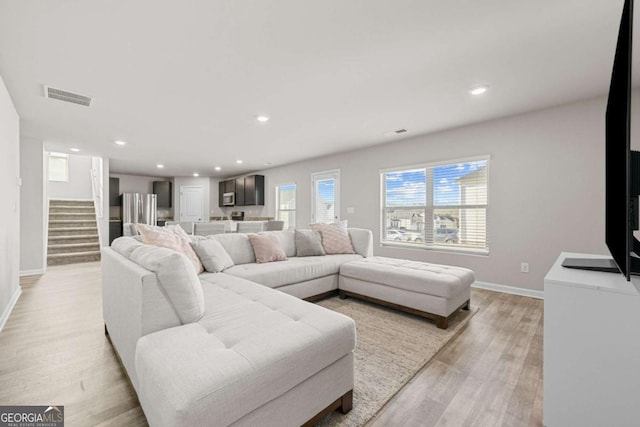 living room with light hardwood / wood-style floors