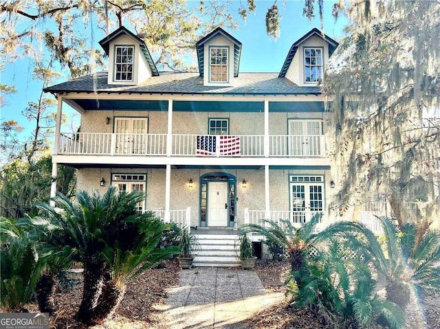 view of front of property featuring a balcony and covered porch