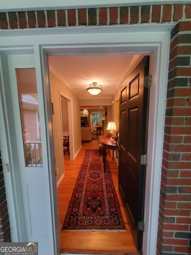 1030 Lake Haynes Dr NE, Conyers, GA 30012 - hallway featuring light wood-type flooring and crown molding