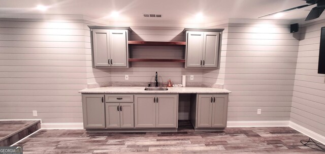 1030 Lake Haynes Dr NE, Conyers, GA 30012 - bar featuring baseboards, wood finished floors, visible vents, and a sink