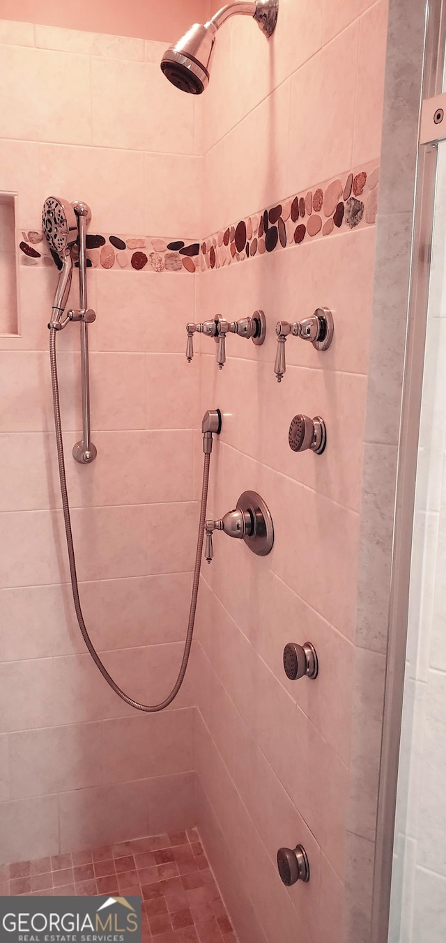 bathroom with tiled shower