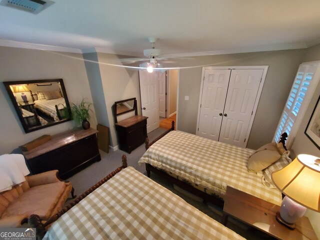 1030 Lake Haynes Dr NE, Conyers, GA 30012 - carpeted bedroom featuring visible vents, a ceiling fan, a closet, crown molding, and baseboards